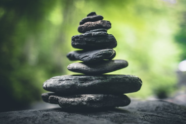 A pile of dark stones stacked on top of each other.